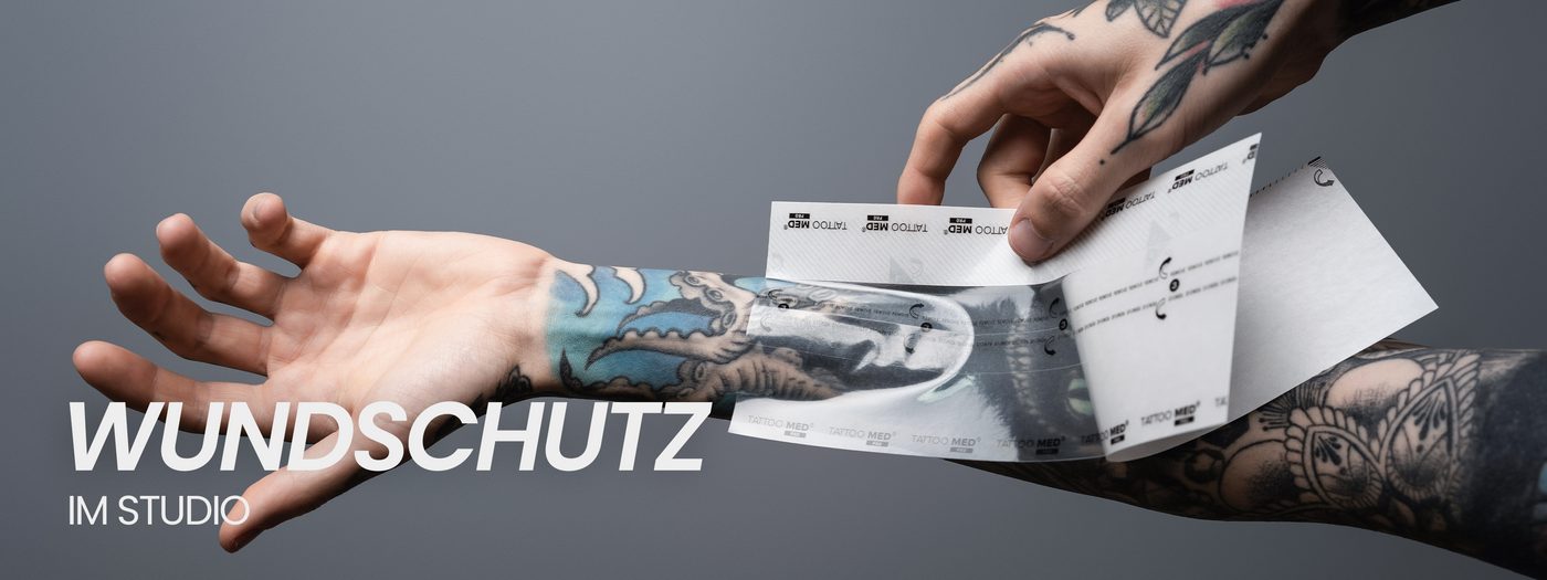 TattooMed protective film being applied to a freshly tattooed arm